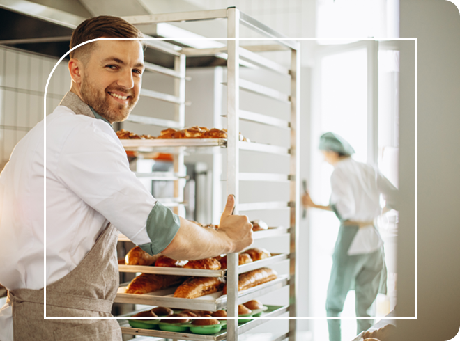 Small bakery business owner moving freshly baked pastries